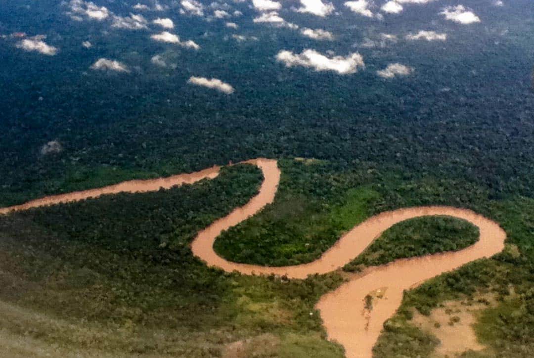 View from the plane of a winding, chocolate-coloured river en route to Ecuador's Amazon Jungle.