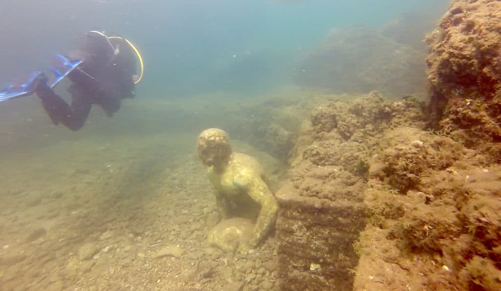 A diver finds a bag of bones on the Coco beach in Badalona