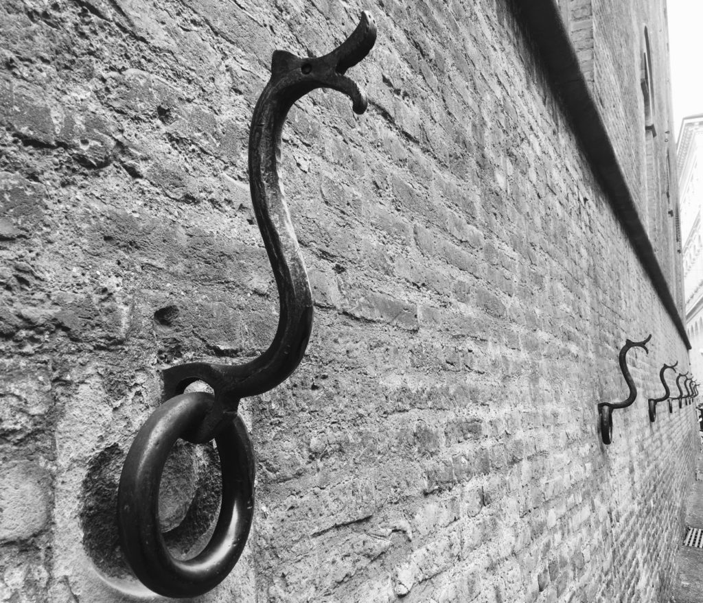 Ornate wall hooks of Bologna, Italy