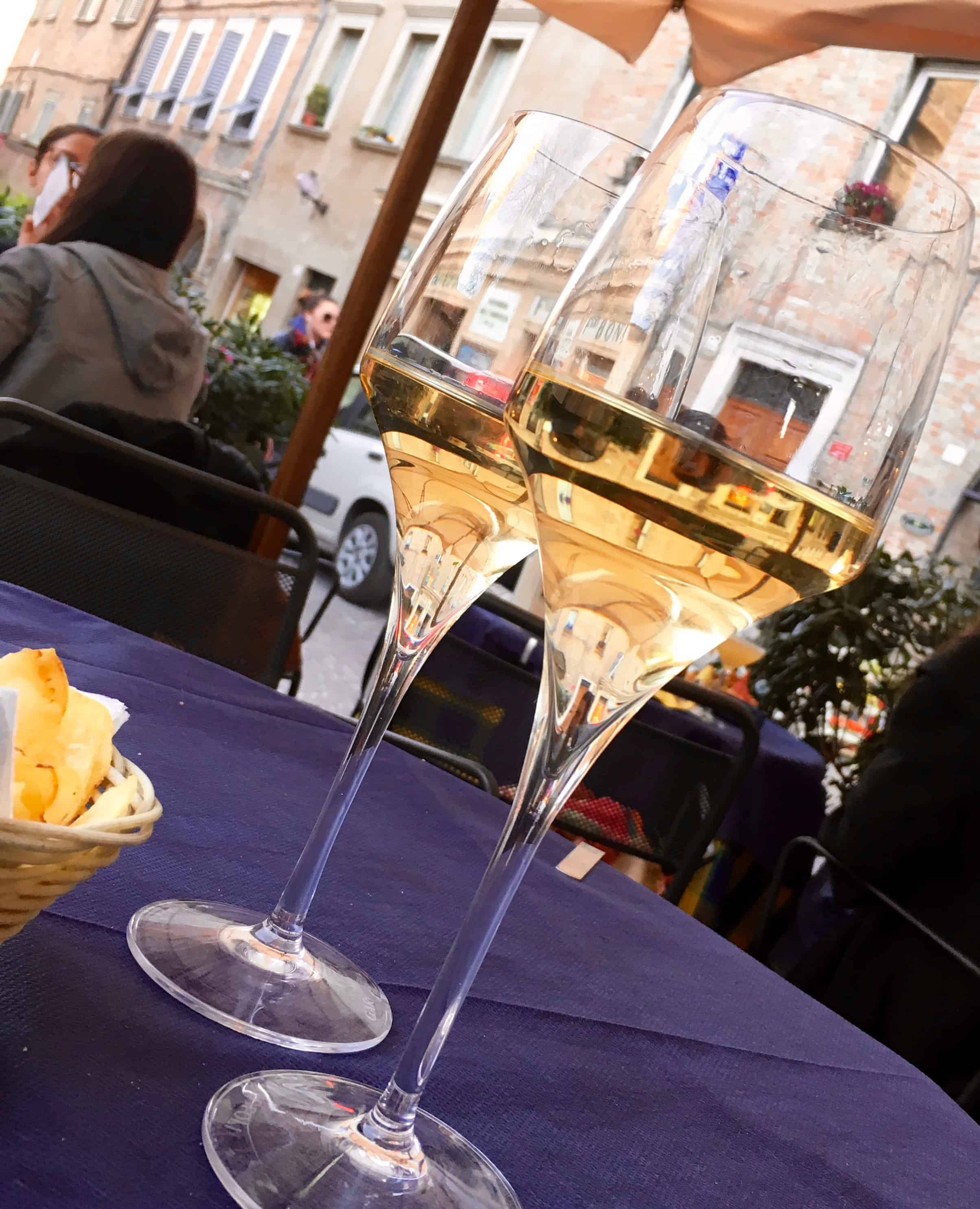 Glasses of local wine Verdicchio in Urbino, Italy