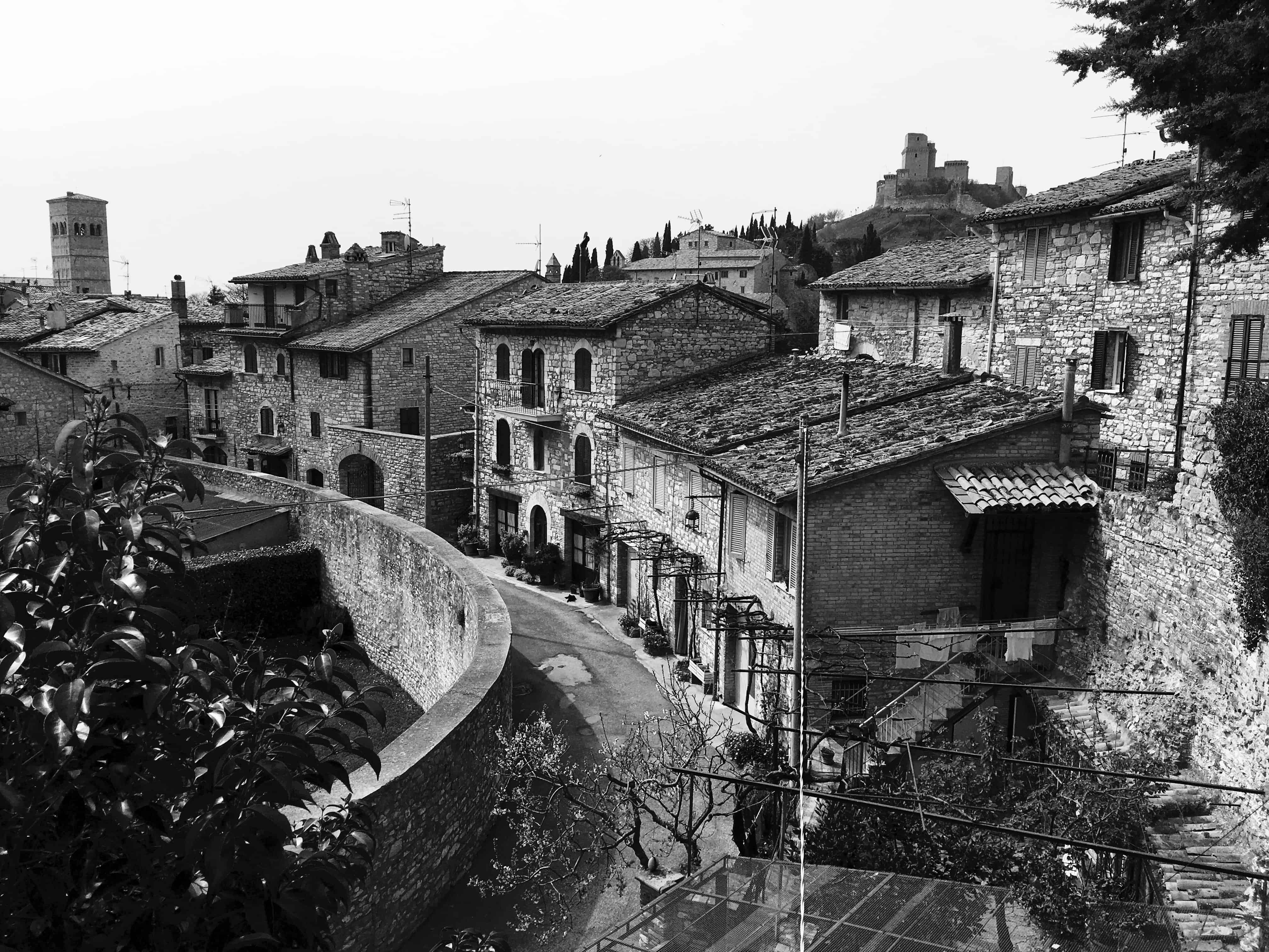 Homes and gardens trace the line of the amphitheatre of ancient Roman Asisium, Assisi