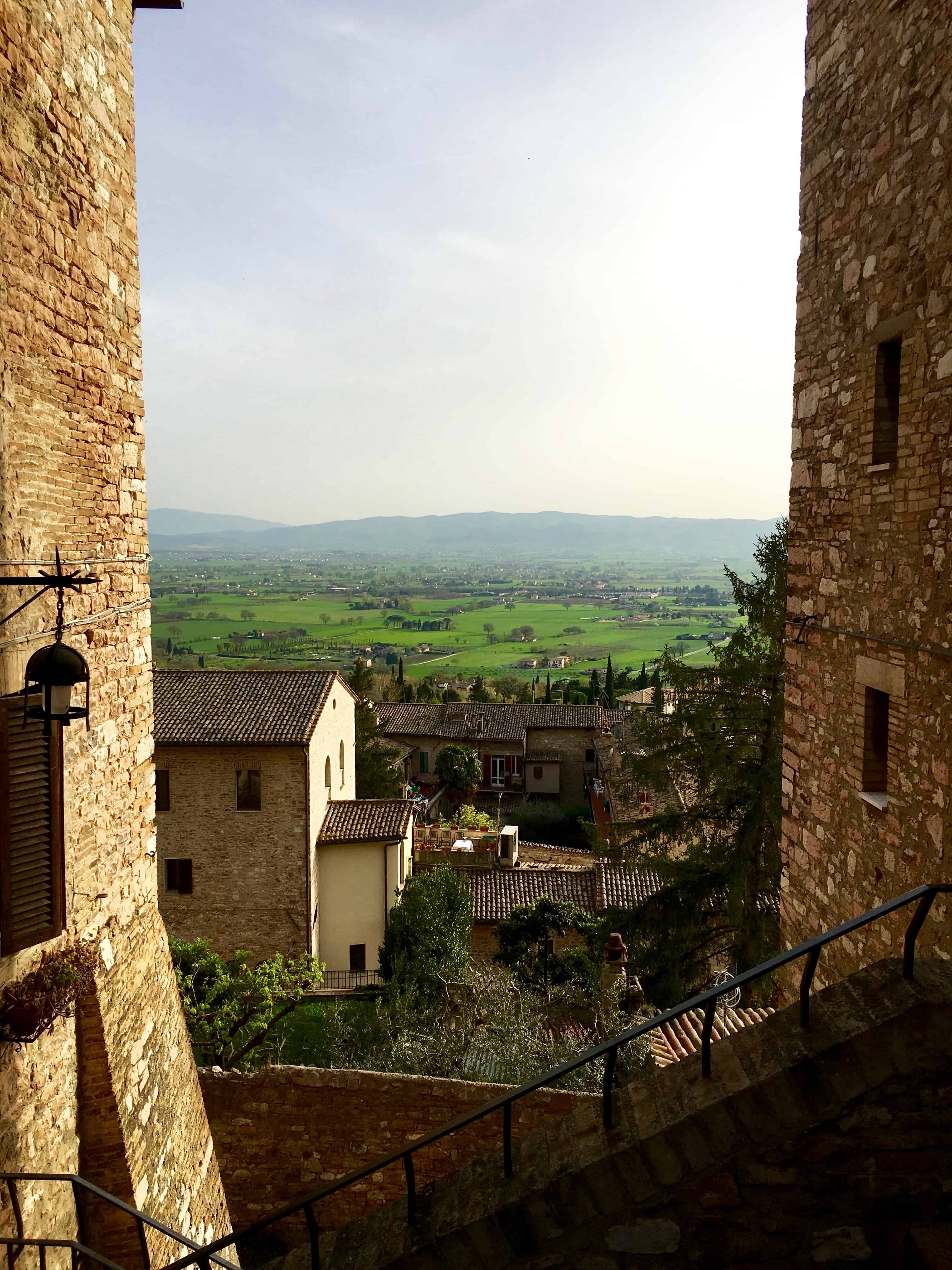 Views between the buildings of Assisi out to the valley below.