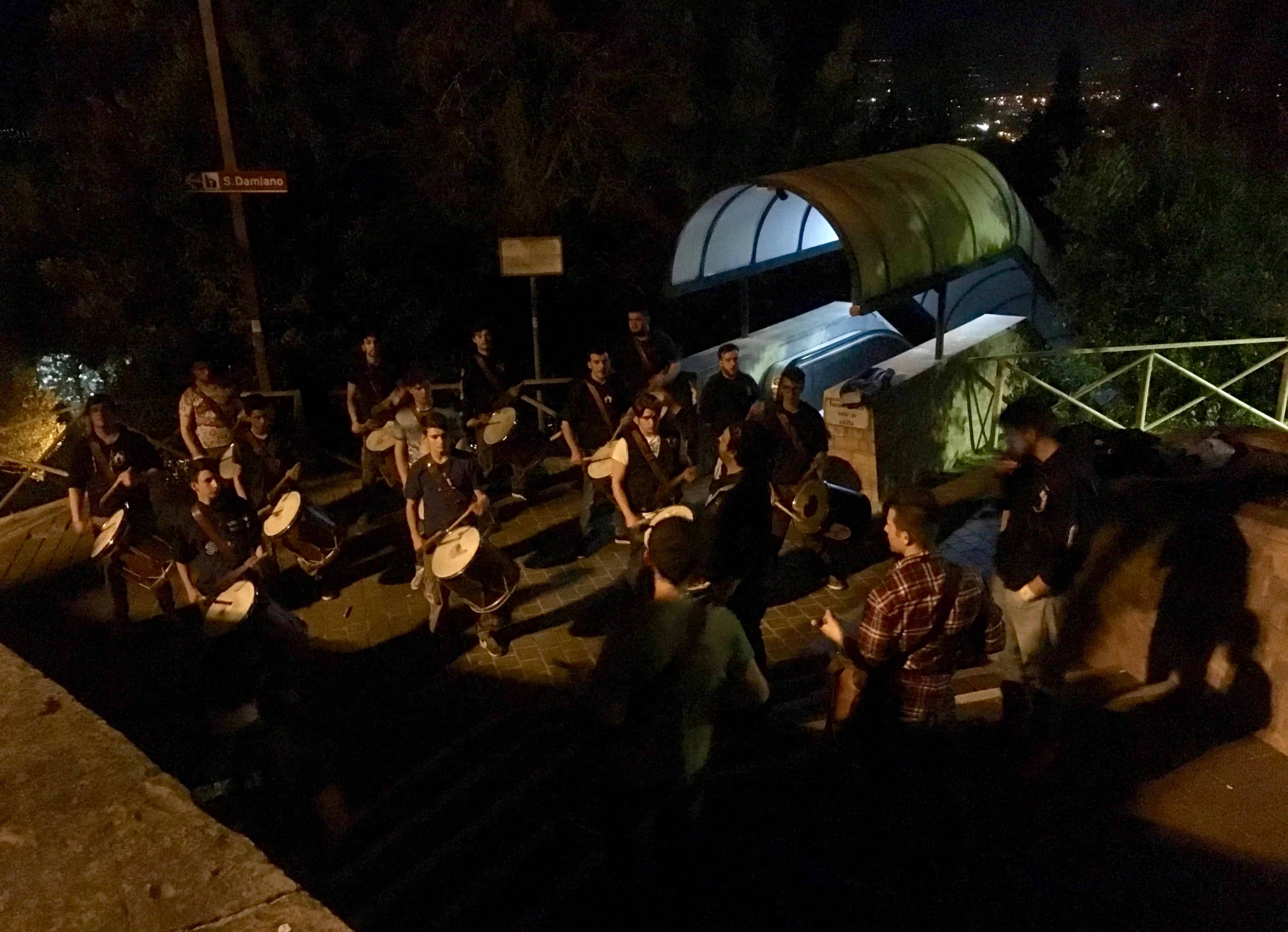 Drummers prepare by night for Assisi's Calendimaggio festival.
