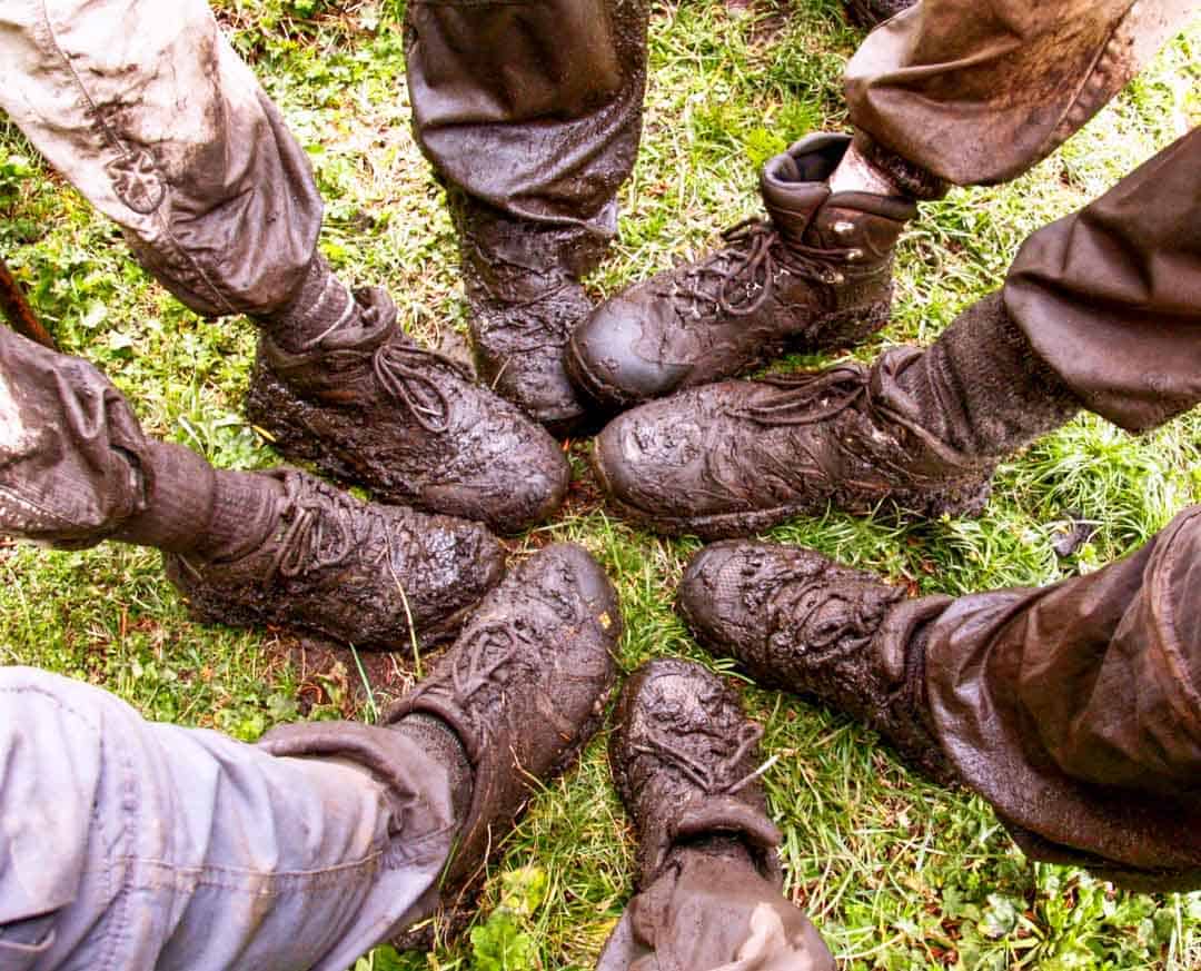 Muddy boots gorilla trekking in Rwanda.