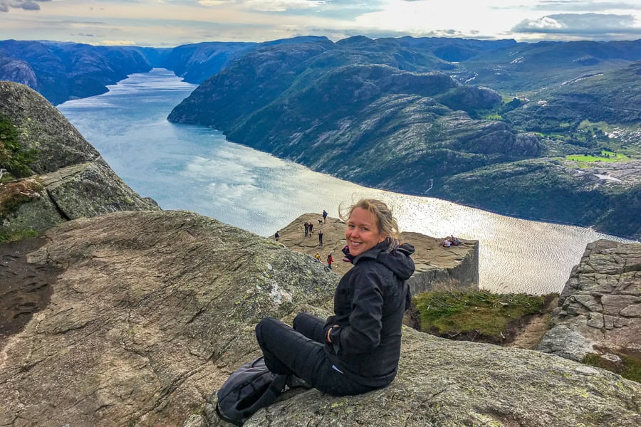 A hiker takes in the view from above Pulpit Rock towards Lysefjord while visiting Norway.