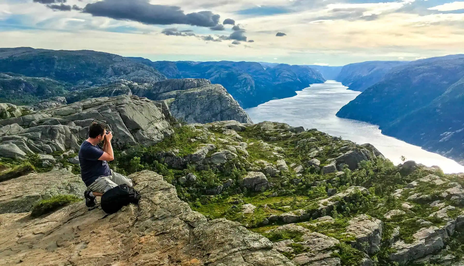 A photographer captures the view over Lysefjord from the Pulpit Rock trail.