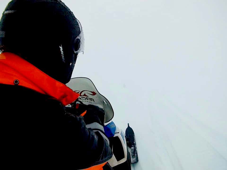 Snowmobiling in a whiteout on Mýrdalsjökull glacier in Iceland