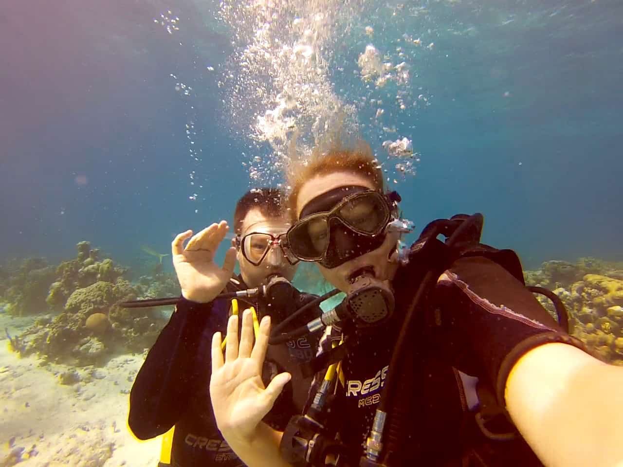 Dan & John wave at the camera on a dive in the Bay of Pigs