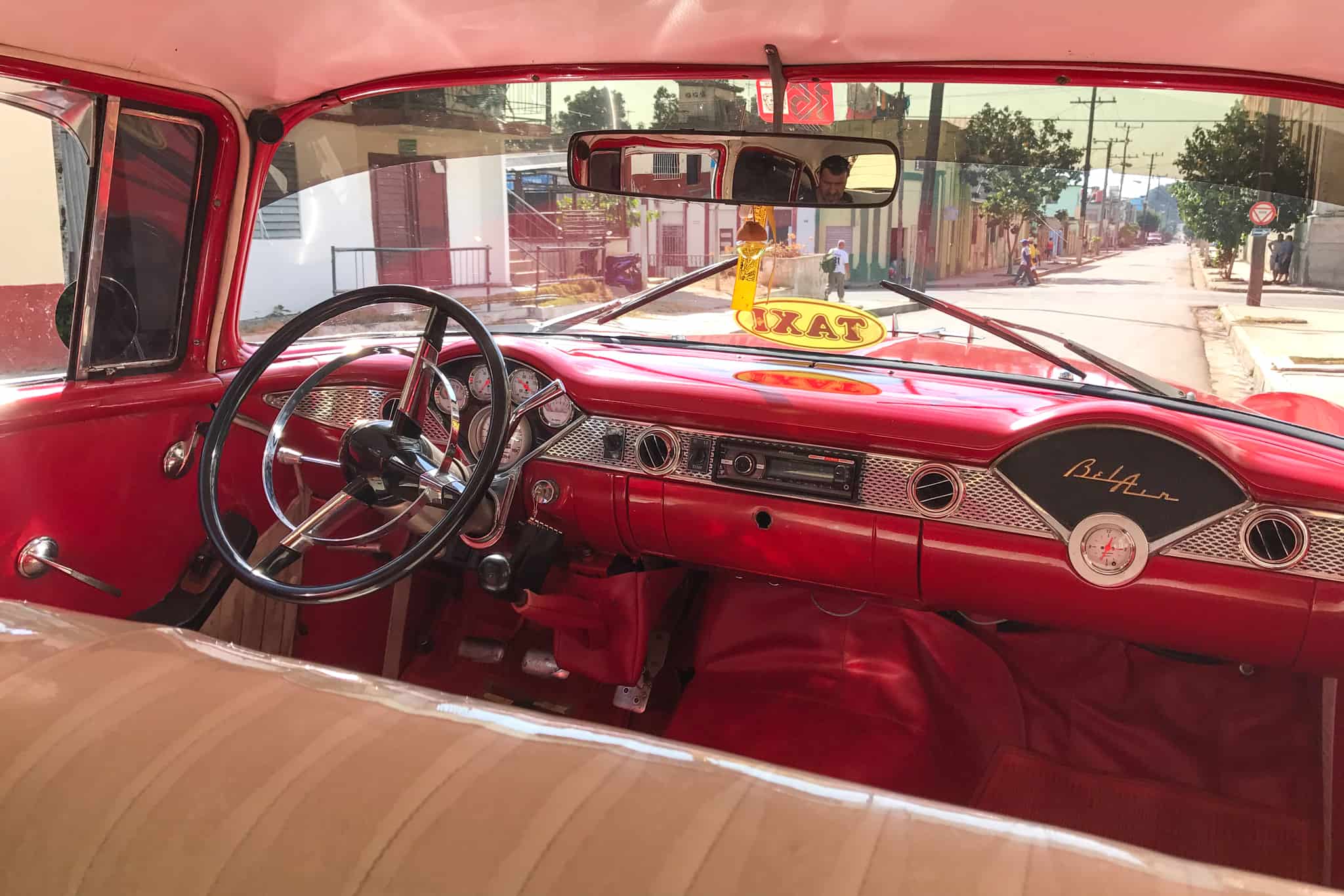 Pink and white interior of a restored vintage Bel Air taxi in Cuba.