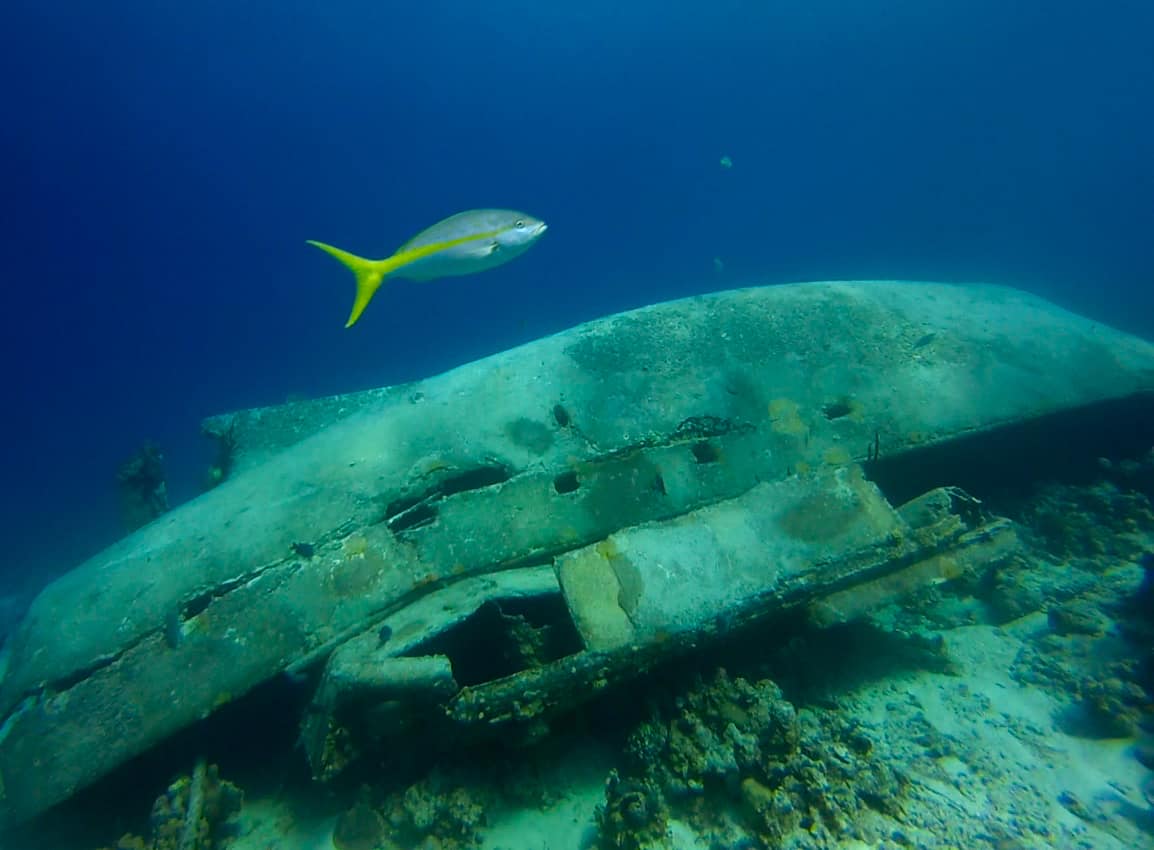 A boat wreck rests on the seafloor in the Bay of Pigs in Cuba