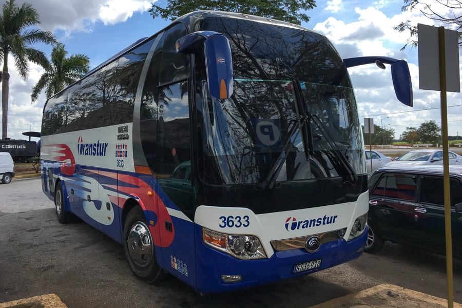 A modern-looking tourist bus, one of the ways to travel in Cuba.