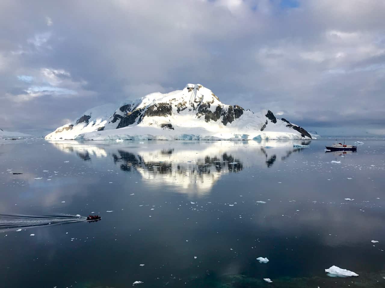 30 Photos Of Antarctica: Looking out over Paradise Harbour towards a large island and an expedition ship in Antarctica.