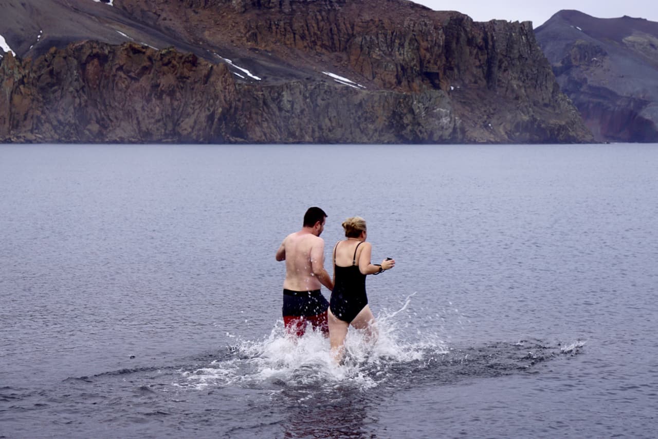 Two take the 'polar plunge' at Deception Island, an experience offered by many expedition ships visiting Antarctica.
