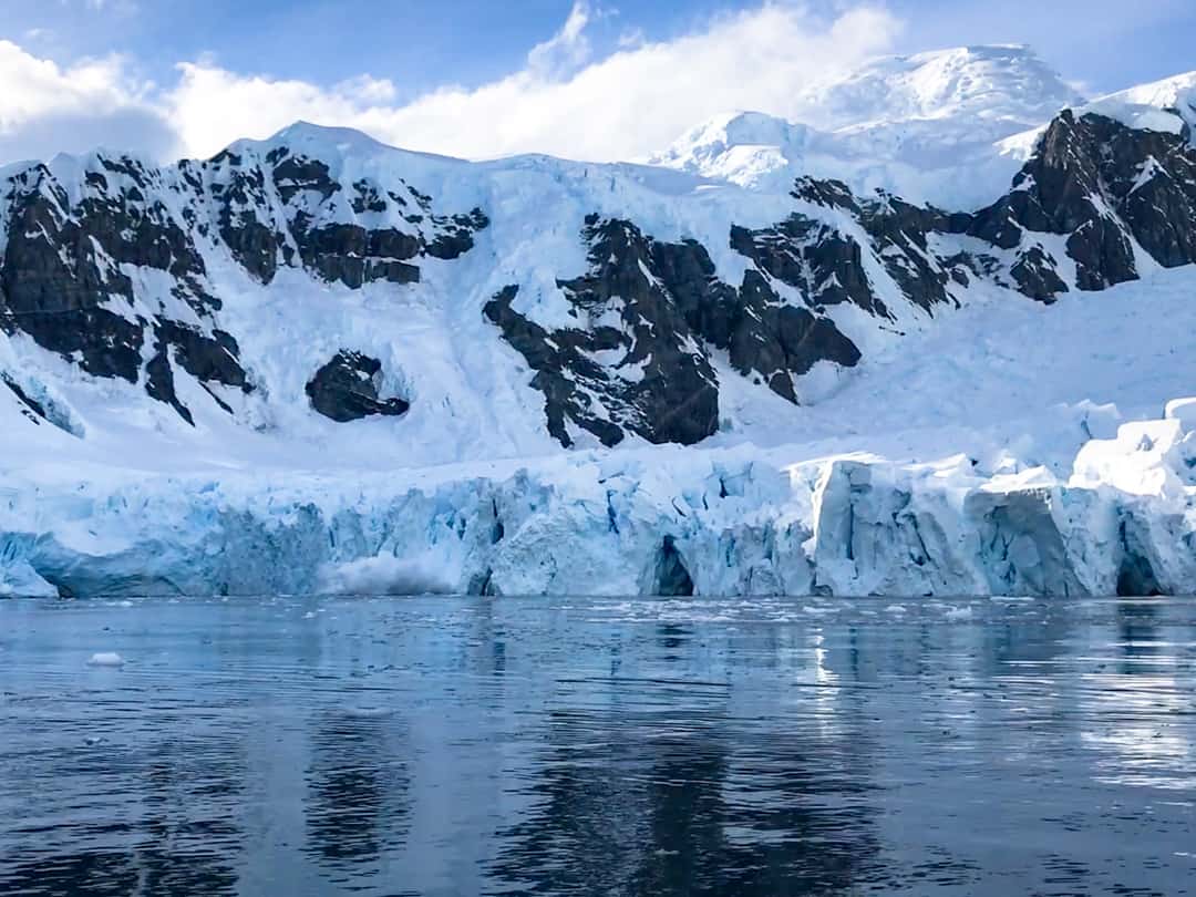 Ice Calves From The Terminus Of The Glacier In Antarctica's Paradise Bay.