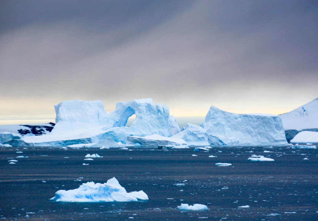 A Cathedral Arch Iceberg In Antarctica.