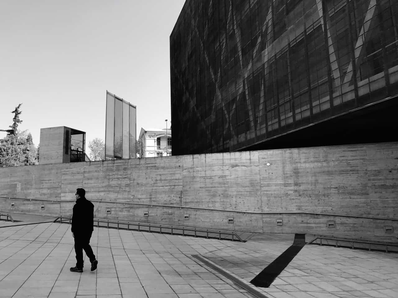 Things to do in Santiago - Black and white image of visitor leaving Santiago's Museum of Memory and Human Rights