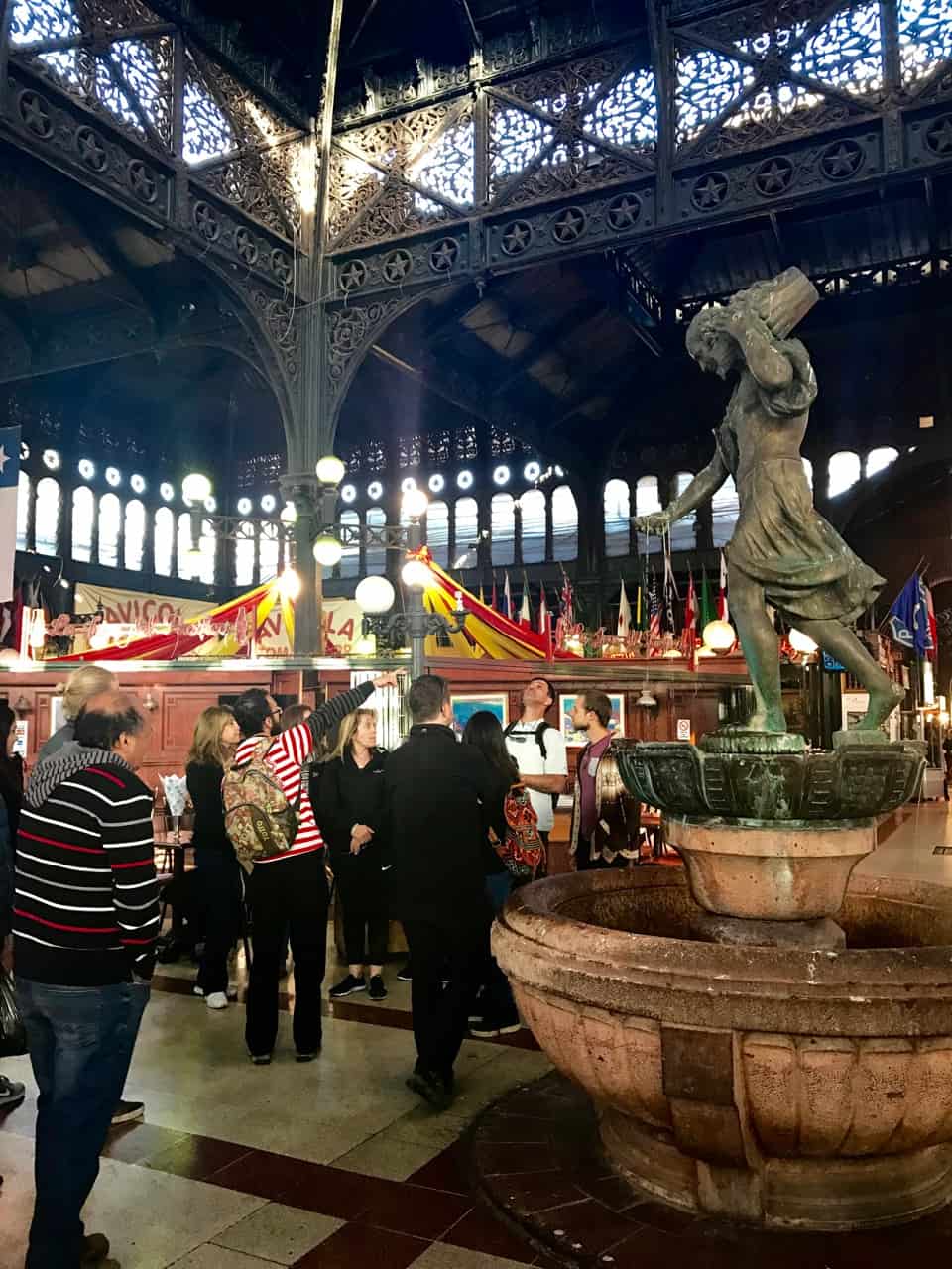 Things to do in Santiago - A Tours4Tips group at the Mercado Central on a Santiago walking tour