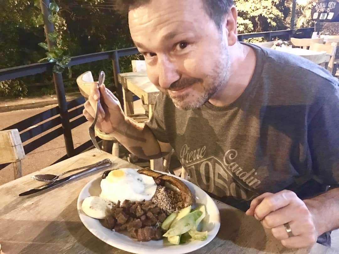 Tucking into Bandeja Paisa, a Colombian food specialty.