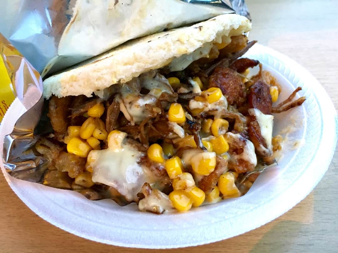 An arepa stuffed with pork, corn and cheese makes for a tasty Colombian sandwich.