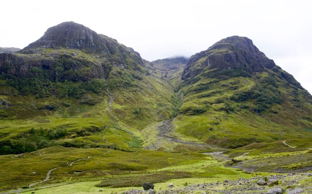 The mountains of Glen Coe rear into the sky.