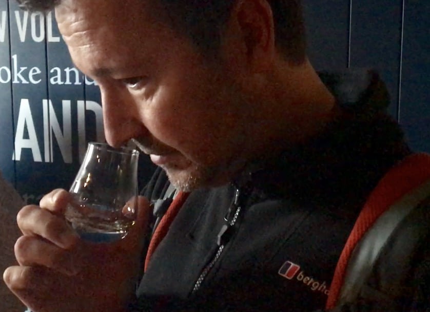 John smells a dram of whisky at Talisker Distillery.