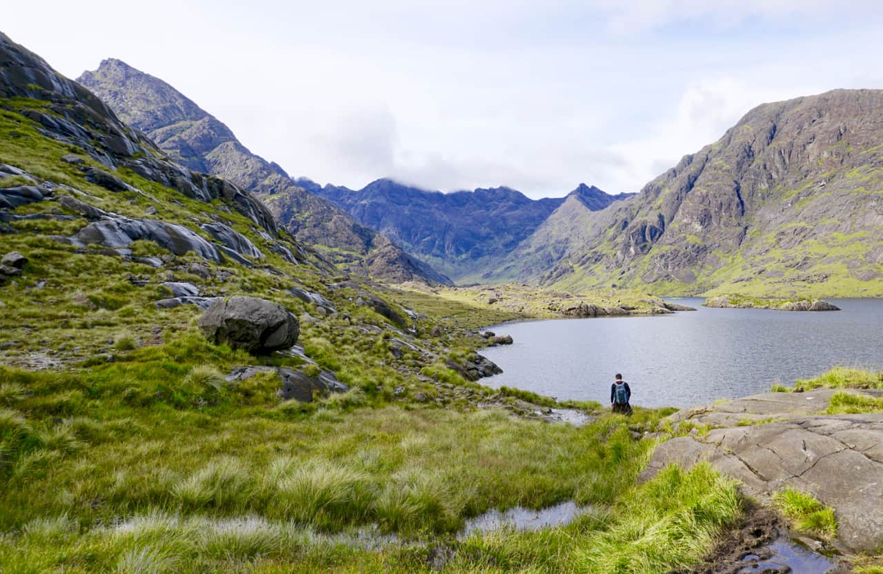 John hikes alongside Loch Coruisk with the Cuillins rising in the background.