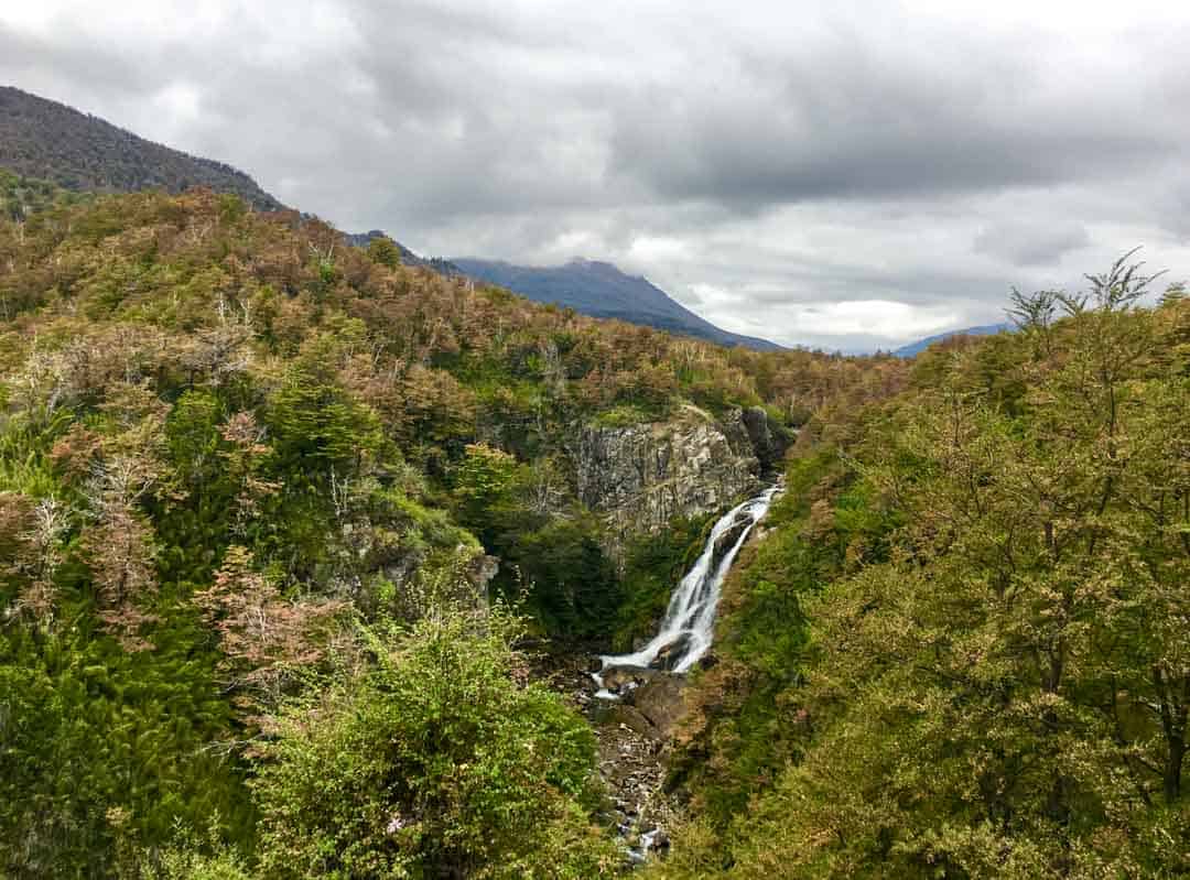 The Vulliñanco Waterfall is visible from the side of the road on the Ruta 40.