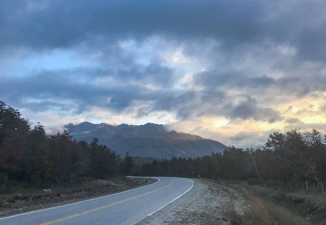 Late afternoon sun lights a mountain ridge on the final stretch of the Ruta de los Siete Lagos on our Patagonia road trip.