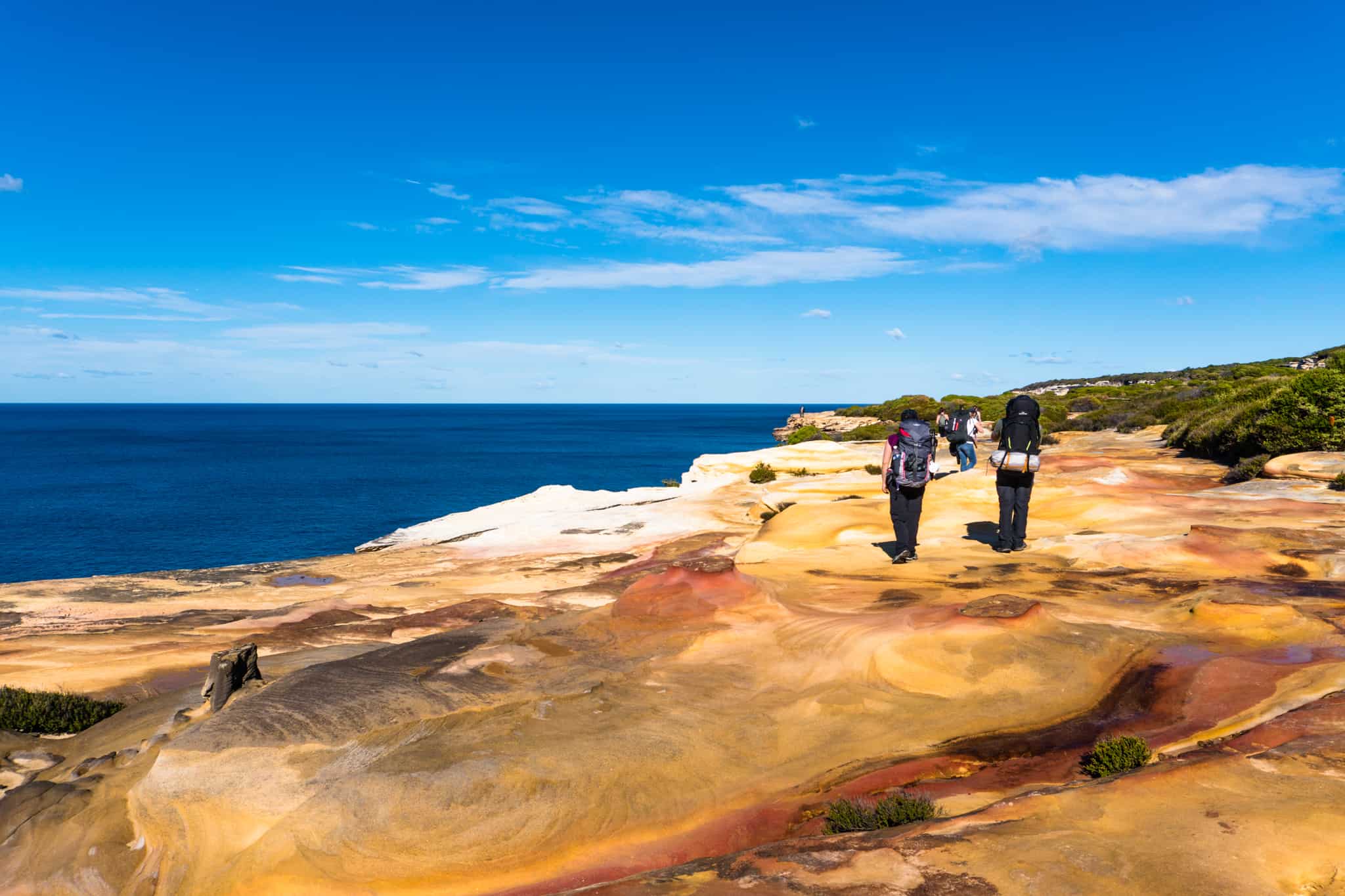 Colourful sandstone offsets the blue ocean and sky on the Coast Track in Royal National Park.