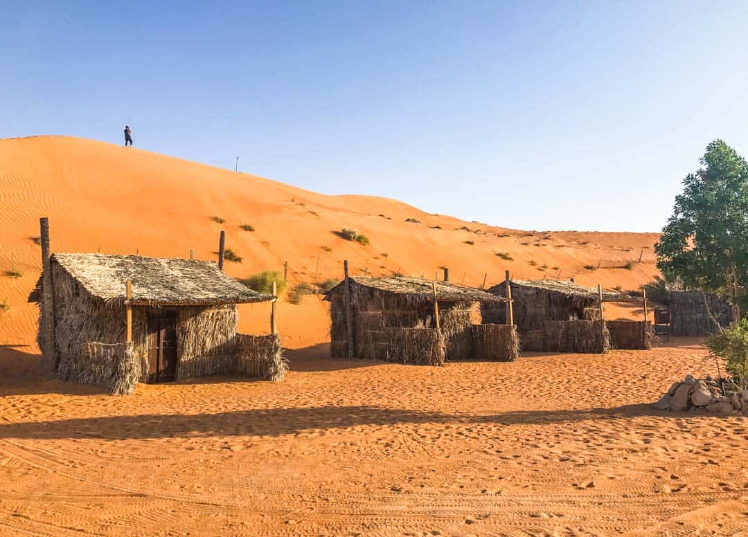 Day 7 of our Oman off road adventure ends with a night in traditional Barasti Huts, clustered below an imposing orange dune.