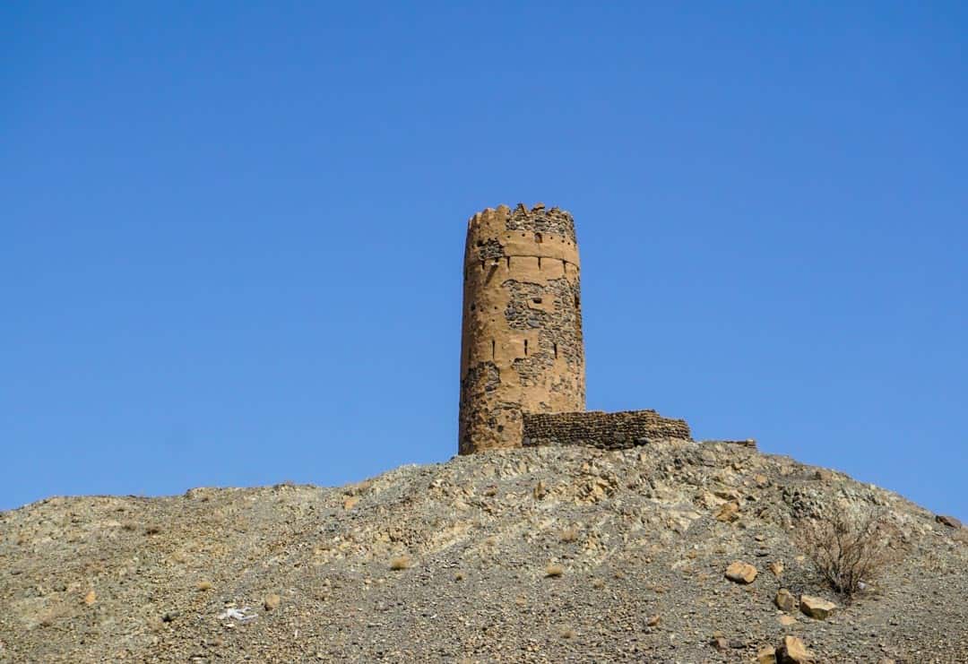 A narrow hilltop watchtower, one of many ancient fortifications you’ll see around the country on an Oman road trip.