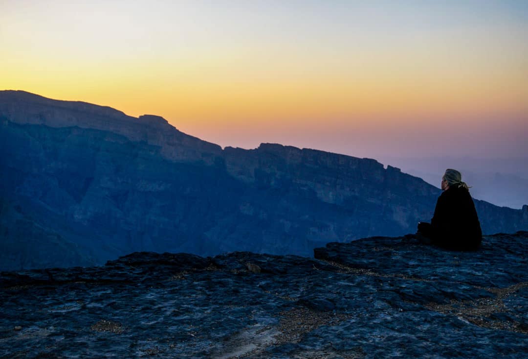 Dawn colours the sky above Wadi Ghul, the Grand Canyon of Arabia on day 11 of our Oman tour.