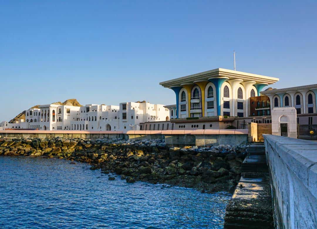 The Sultan's Palace in Old Muscat looks majestically across the water - one of the Oman highlights that shouldn’t be missed.