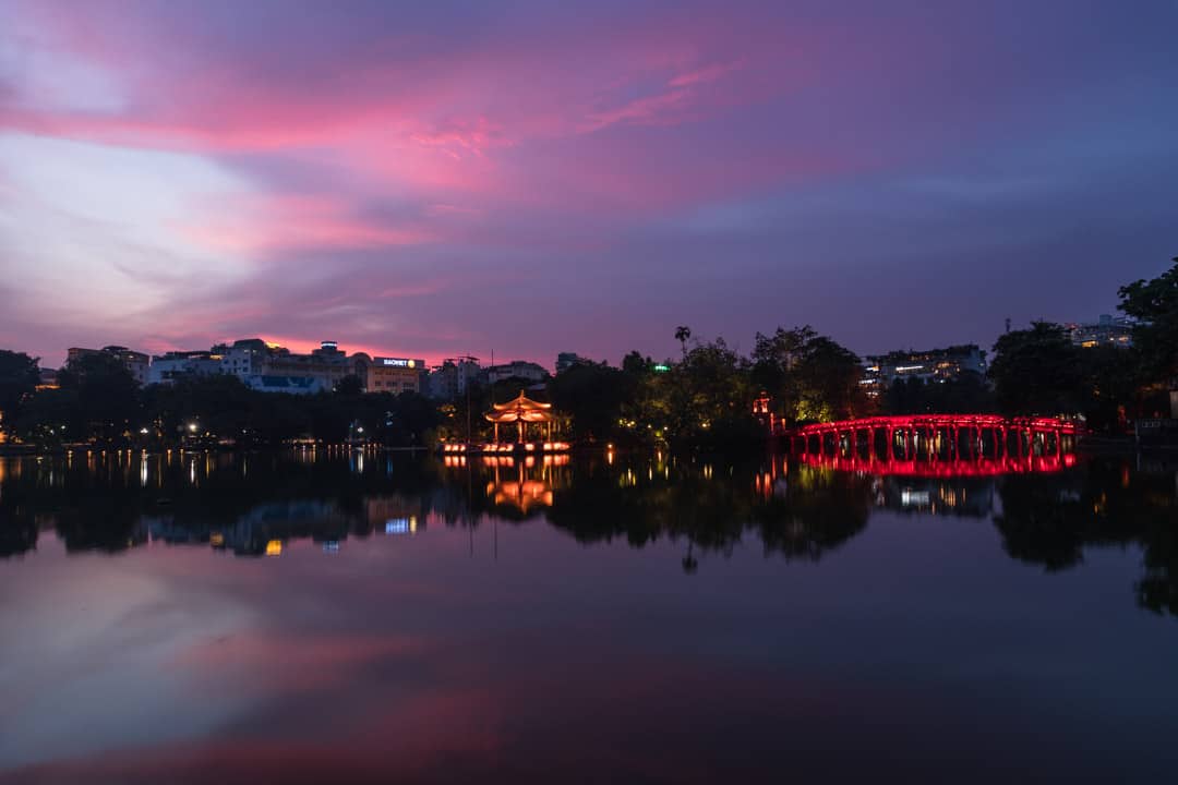 Highlights of Hanoi - The Red Bridge lights up at night over Hoan Kiem Lake.