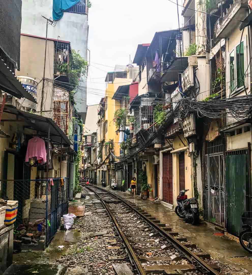 Off The Beaten Track In Vietnam: Narrow houses line the track on Train Street in Hanoi.