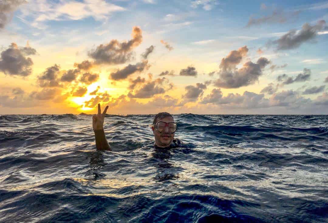 Dawn Scuba Diver John Waves Before Submerging At Great Barrier Reef
