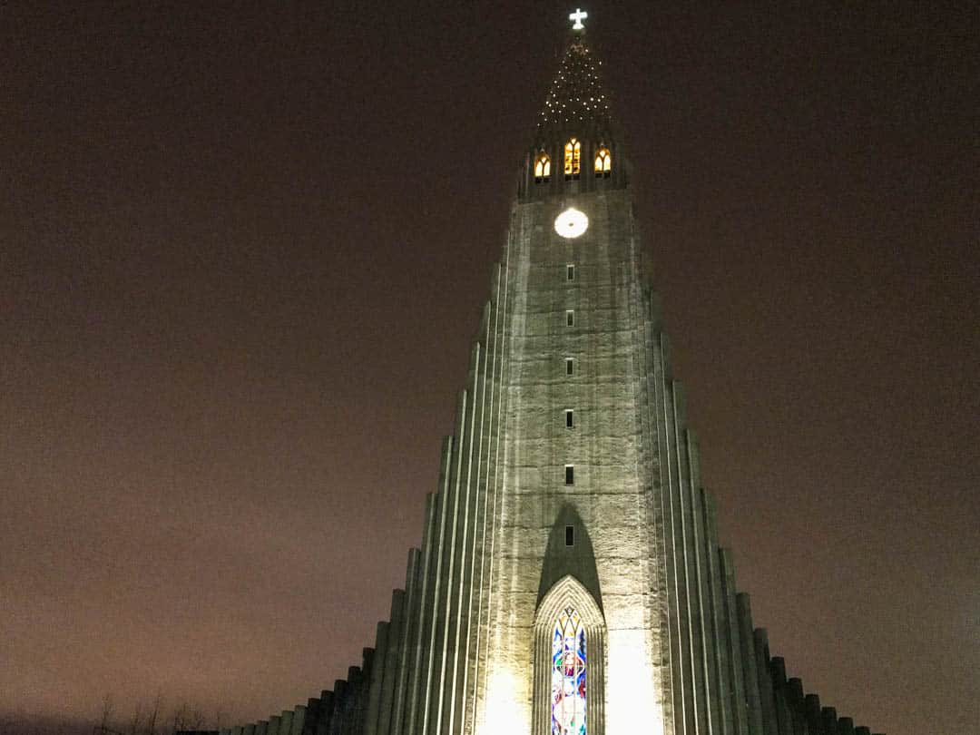 Hallgrímskirkja rises into the night sky in Reykjavik.