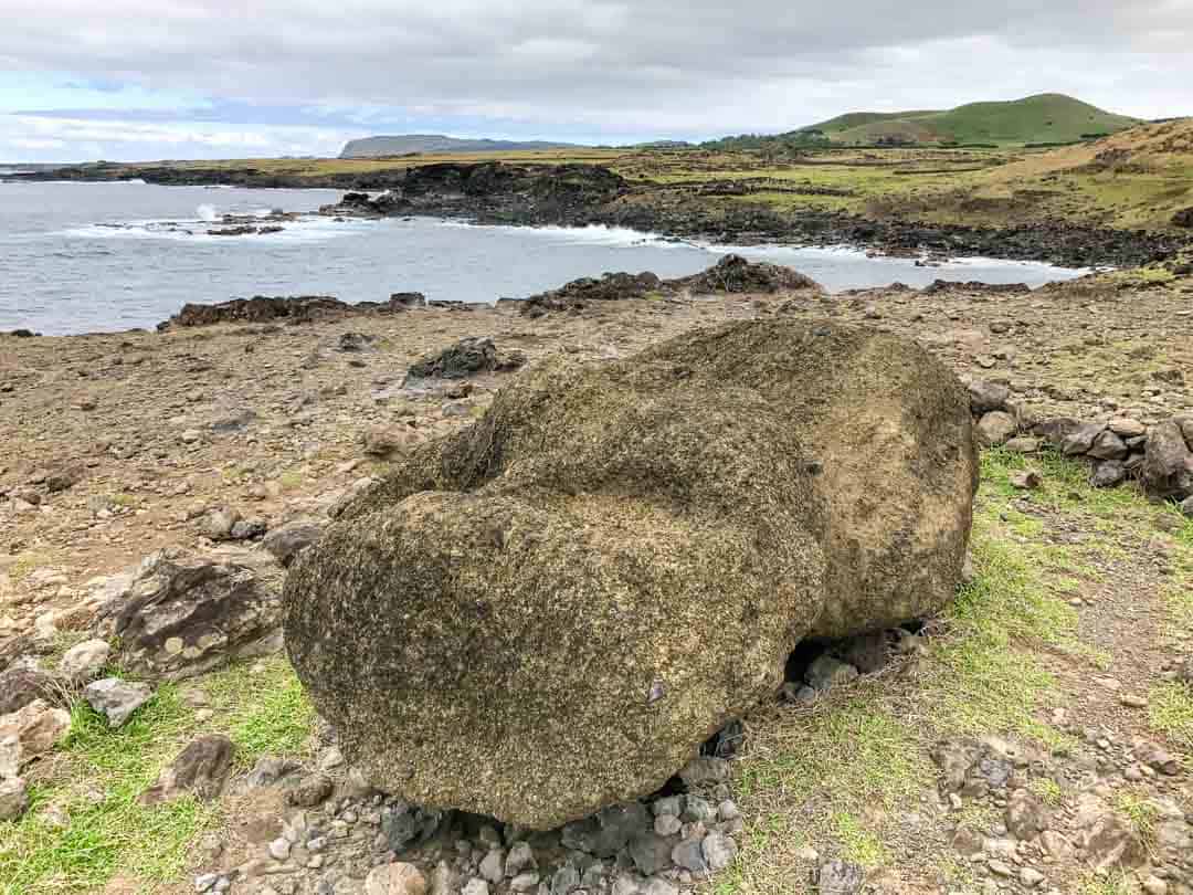 Easter Island Itinerary: A broken moai head lies abandoned next to the sea.