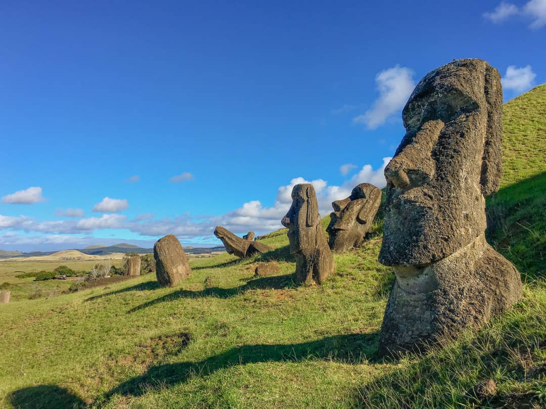 The famous Easter Island heads of Rano Raraku, buried on the slopes of an ancient volcano.