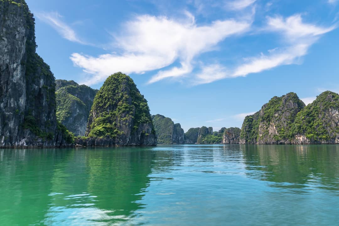 Limestone islands speckle the waters of Bai Tu Long Bay and Halong Bay.