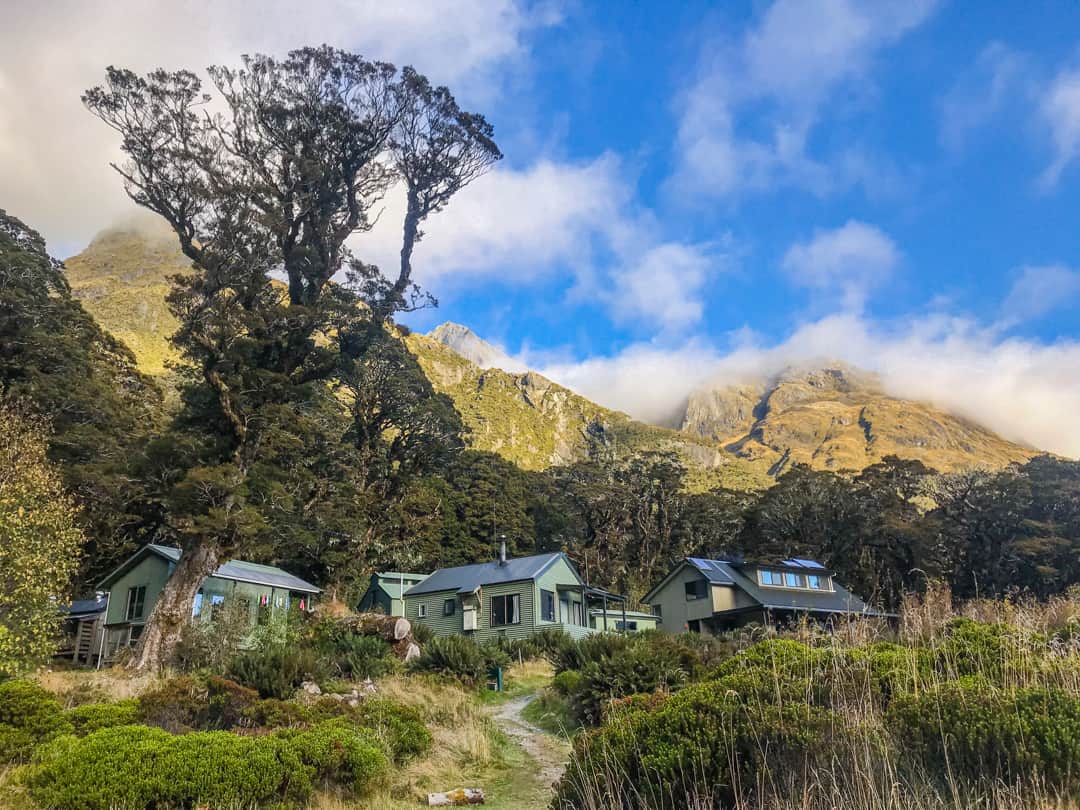 Lake Mackenzie Huts Surrounded By Mountains On New Zealand's Routeburn Track.