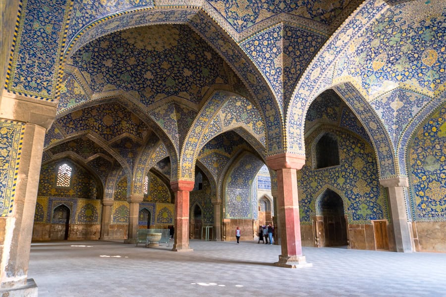 Visitors admire the vivid tiles and vaulted ceilings of Esfahan's Shah Mosque, one of our favourite places to visit in Iran.