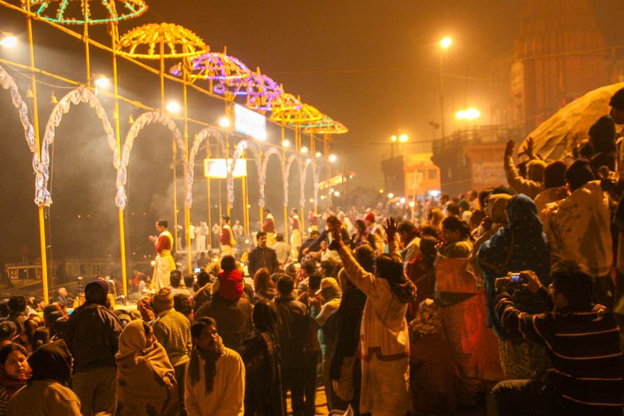 Large crowds enjoy the nightly Hindu Aarti ceremony at the Ganges in Varanasi, the perfect place to end an India road trip.
