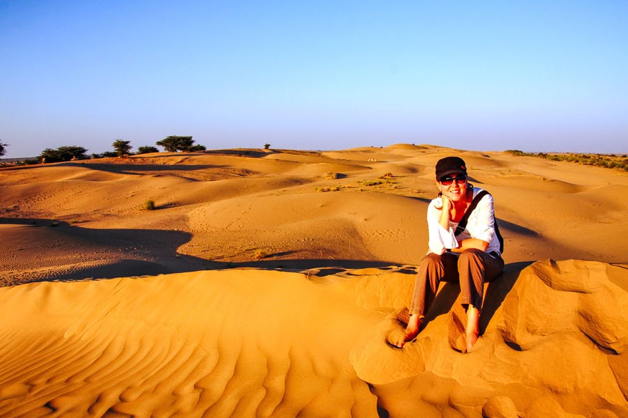 The desert turns burnt orange as the sun sets over Sam Sand Dunes near Jaisalmer, one of our Rajasthan highlights