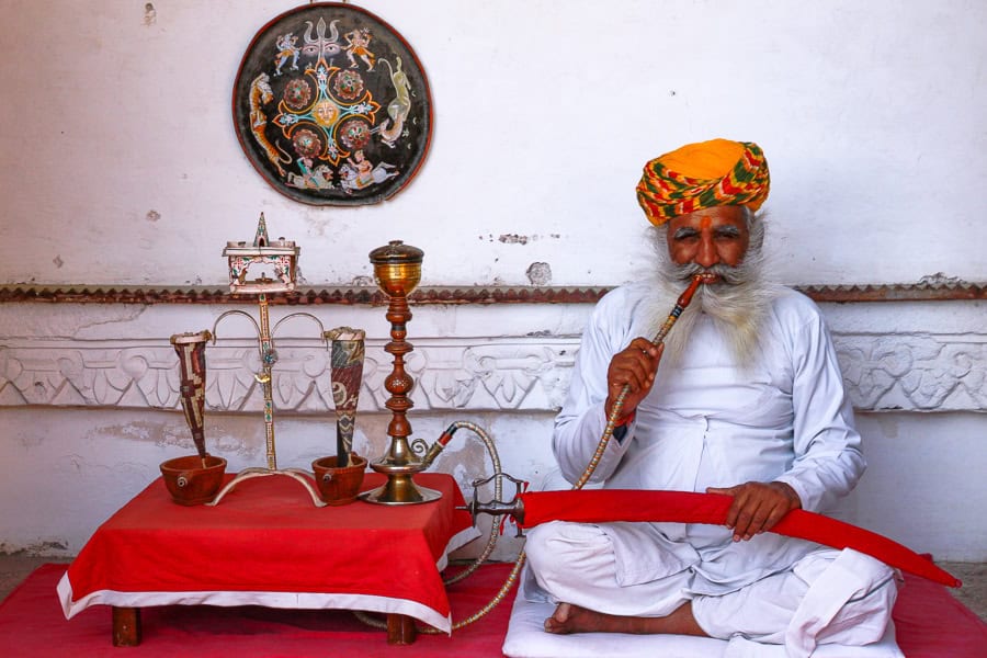 A ‘wise man’ smoking a pipe at Meherangarh Fort – a must visit highlight of our itinerary for India.
