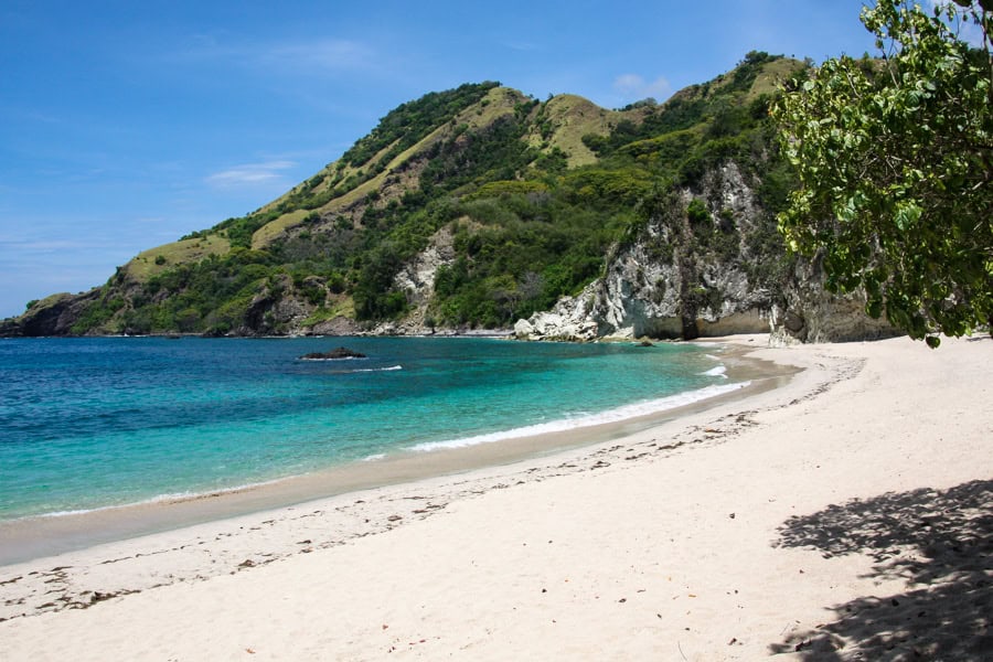 Beautiful Koka Beach, a crescent of turquoise fringed sand backed by hills - another highlight of our Flores road trip