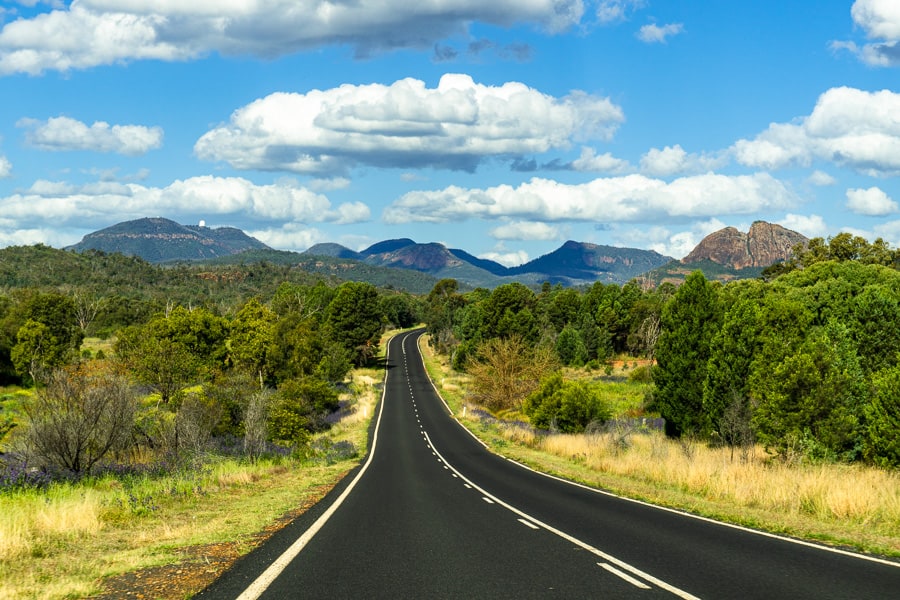 Australian Road Trip: A road winds off towards the Warrumbungles range in NSW.