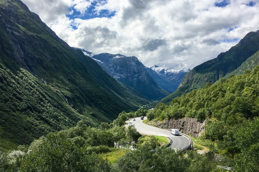 Road Trip Europe: Road winds through green mountains in Norway.