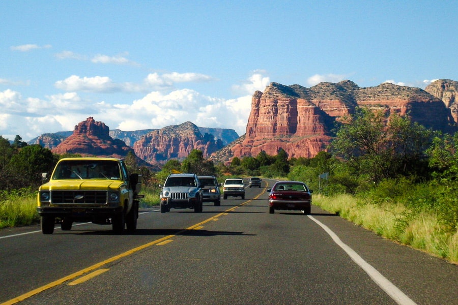 Road trips around the world: The rocky rises of Sedona tower over the road.