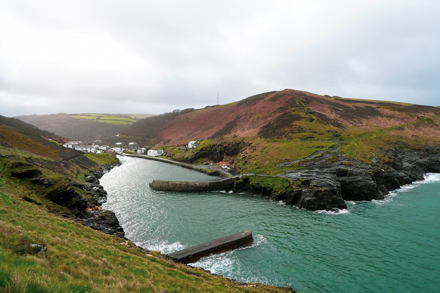 The ocean flows in to Boscastle village between cliffs and seabreaks.